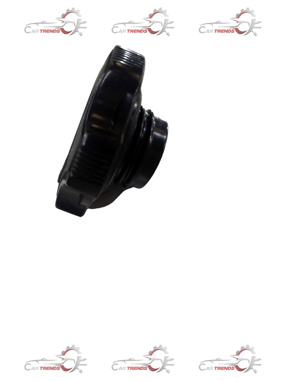 Maruti Suzuki oil cap filler showing the black plastic oil cap with metal insert and brand logo for engine oil filling.