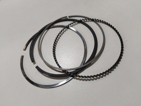 Maruti Suzuki piston ring set for WagonR, A-Star, and Estilo models, showing a close-up of the engine piston rings.