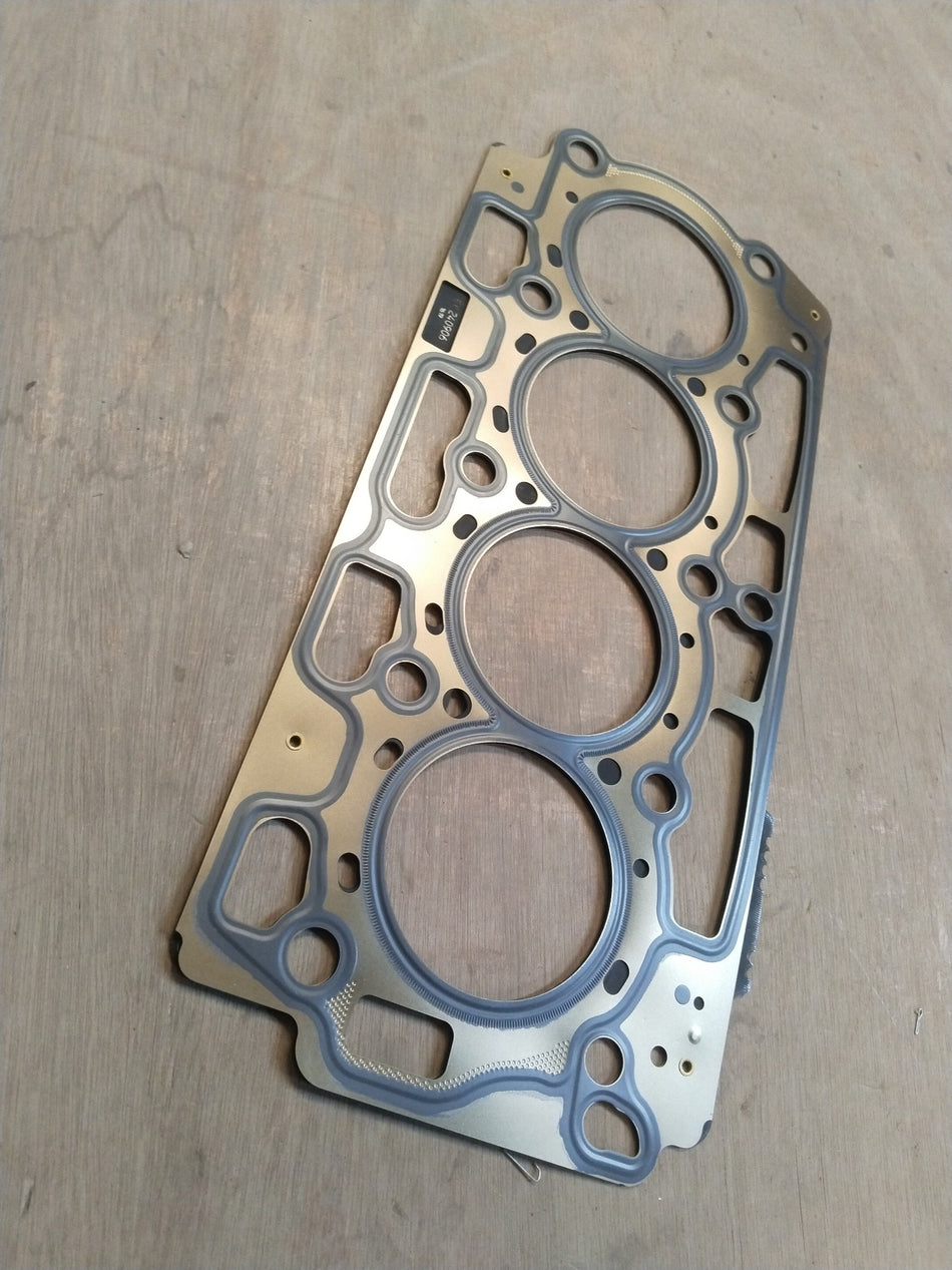 Ford cylinder head gasket, part #AV2Z6051D, showing metal and rubber layers for engine sealing in a close-up view.