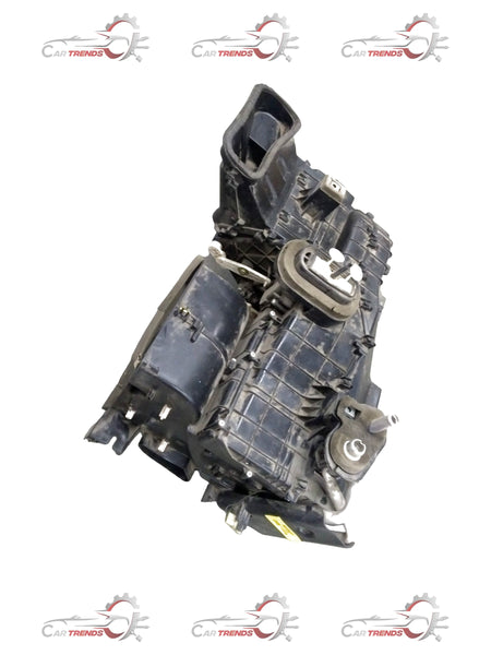 General Motors Chevrolet Beat air conditioning evaporator module assembly showing metal components and connectors.