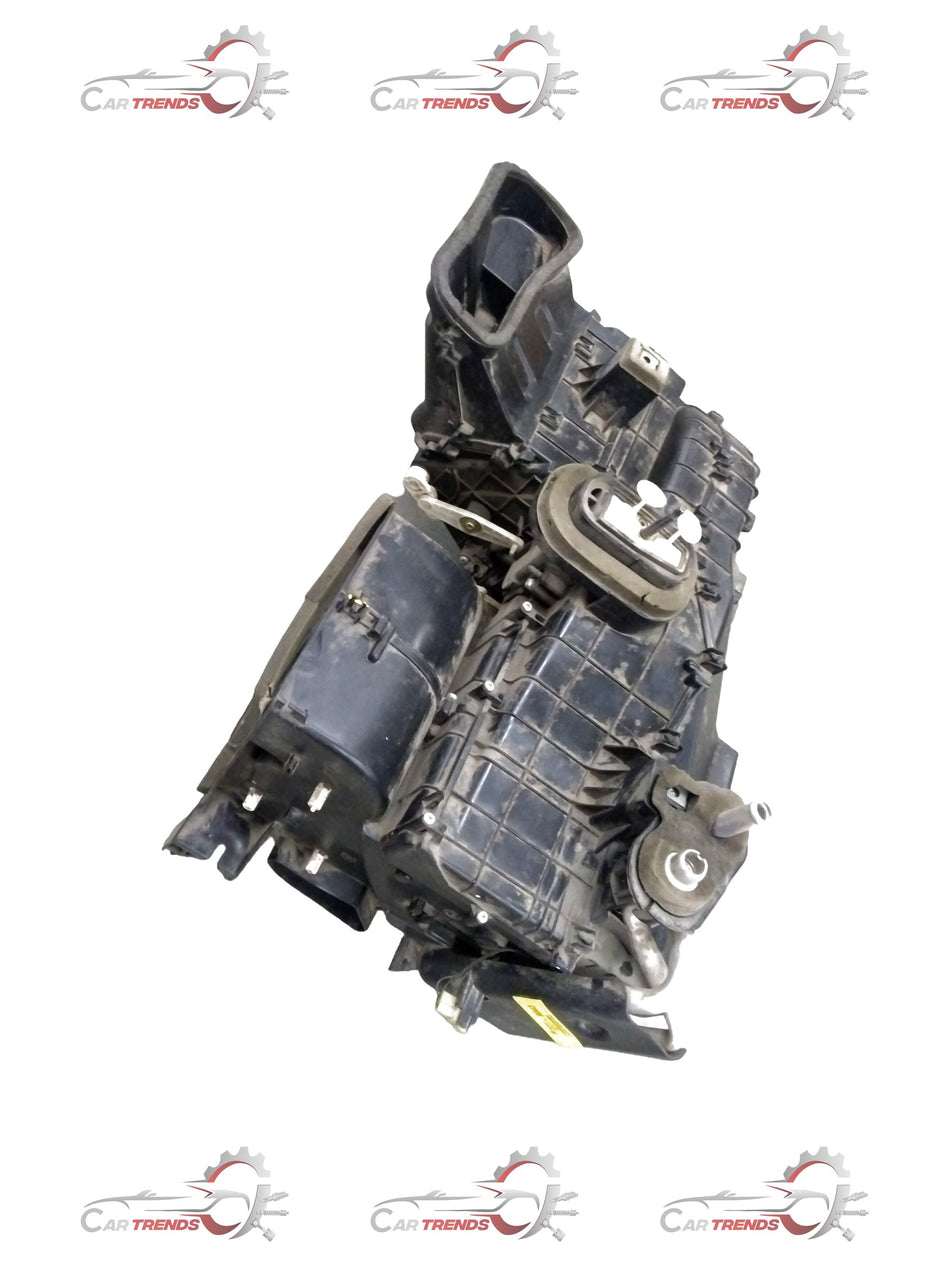 General Motors Chevrolet Beat air conditioning evaporator module assembly showing metal components and connectors.