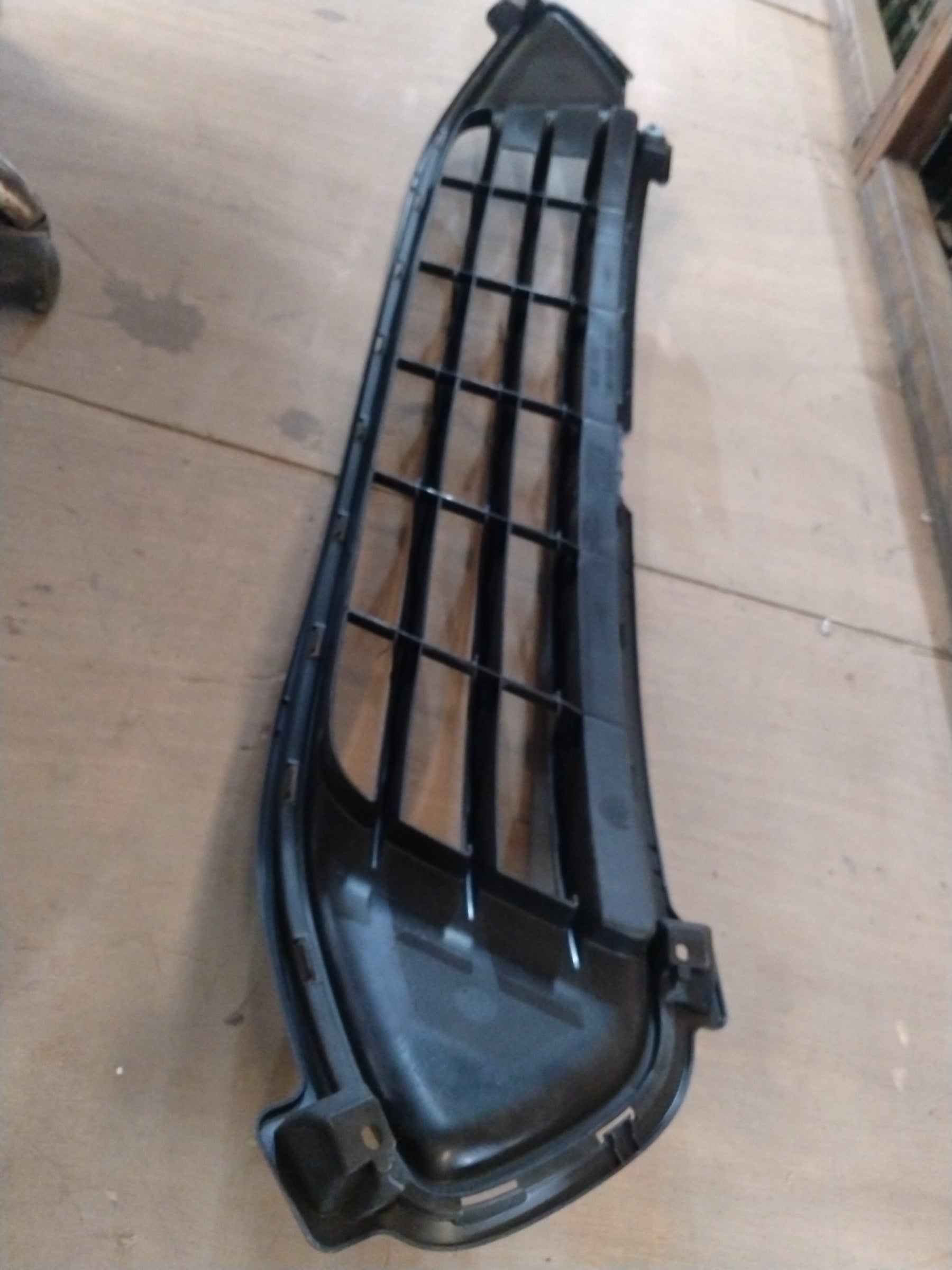 Toyota radiator lower grille by CarTrends, showing close-up of black plastic grille with mounting points and textured surface.