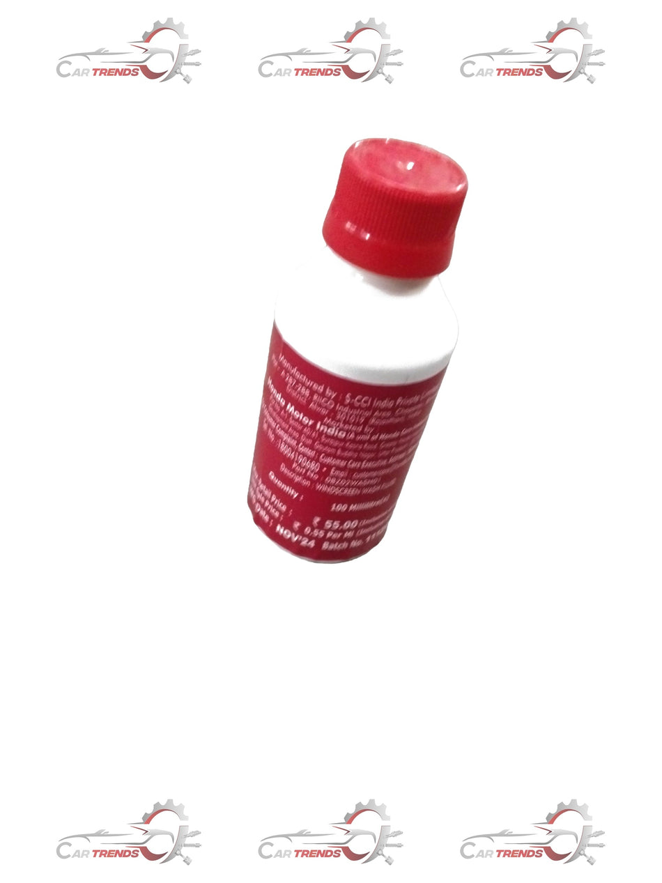 Honda windscreen fluid bottle with clear label and blue cap, ready for vehicle windshield cleaning.