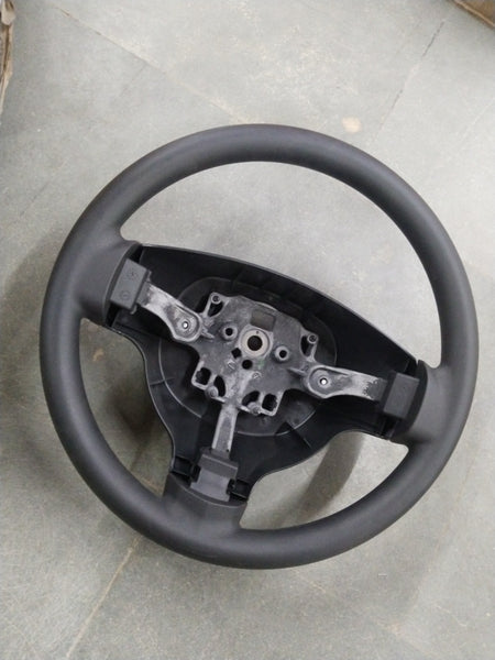 General Motors Chevrolet Enjoy steering wheel assembly, showing the black wheel and mounting components in a detailed image.