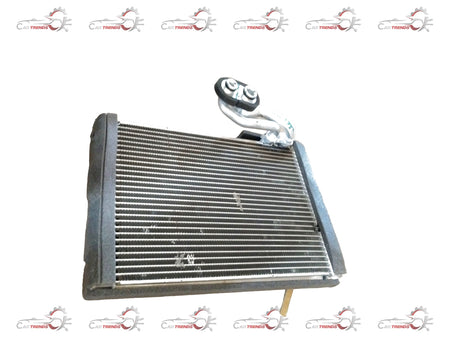 Maruti Suzuki EVAPORATOR SUB ASSY 95411M56R00 showing the automotive air conditioning component with metal fins and connectors.