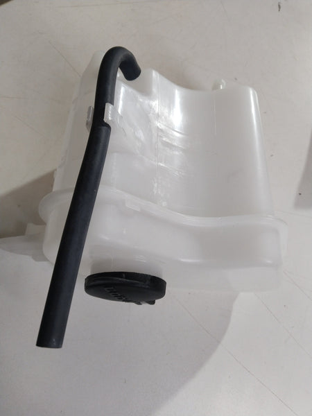 Hyundai Grand i10 expansion tank coolant bottle showing the plastic reservoir with cap for engine cooling system.