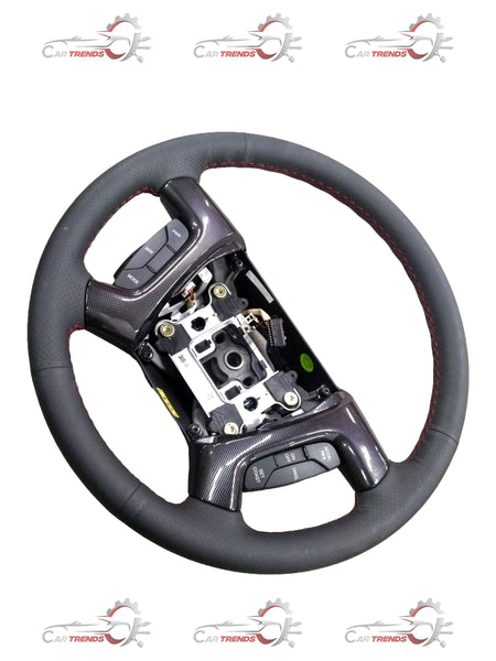 Steering wheel for Chevrolet Enjoy by General Motors, showing a close-up of the black plastic and metal components.
