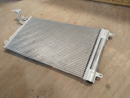 Volkswagen refrigerant condenser for Polo, Vento, Taigun, and Virtus models, showing the metal core and cooling fins.