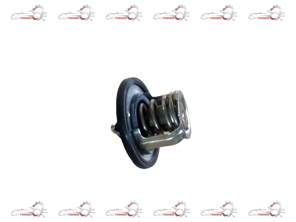 Maruti Suzuki thermostat (82°C) showing metal housing and connection points, used for engine temperature regulation.