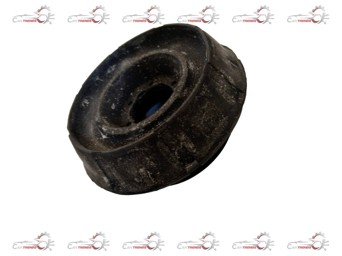 Nissan suspension strut for Mahindra Everito, showing the coil spring and mounting components in a close-up image.