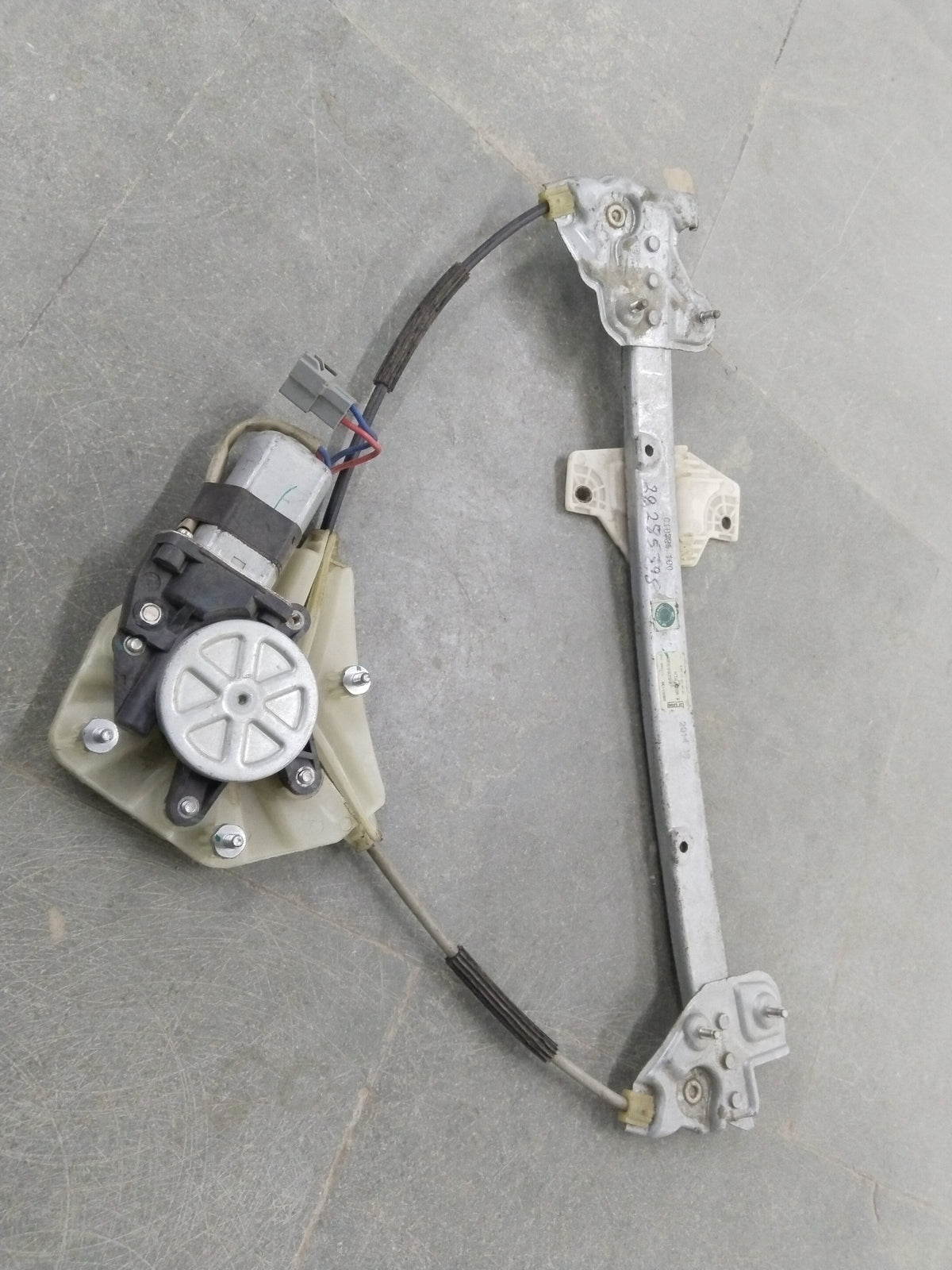 Front left electric window regulator assembly for Chevrolet Spark, showing the motor and mechanical parts in a clear image.