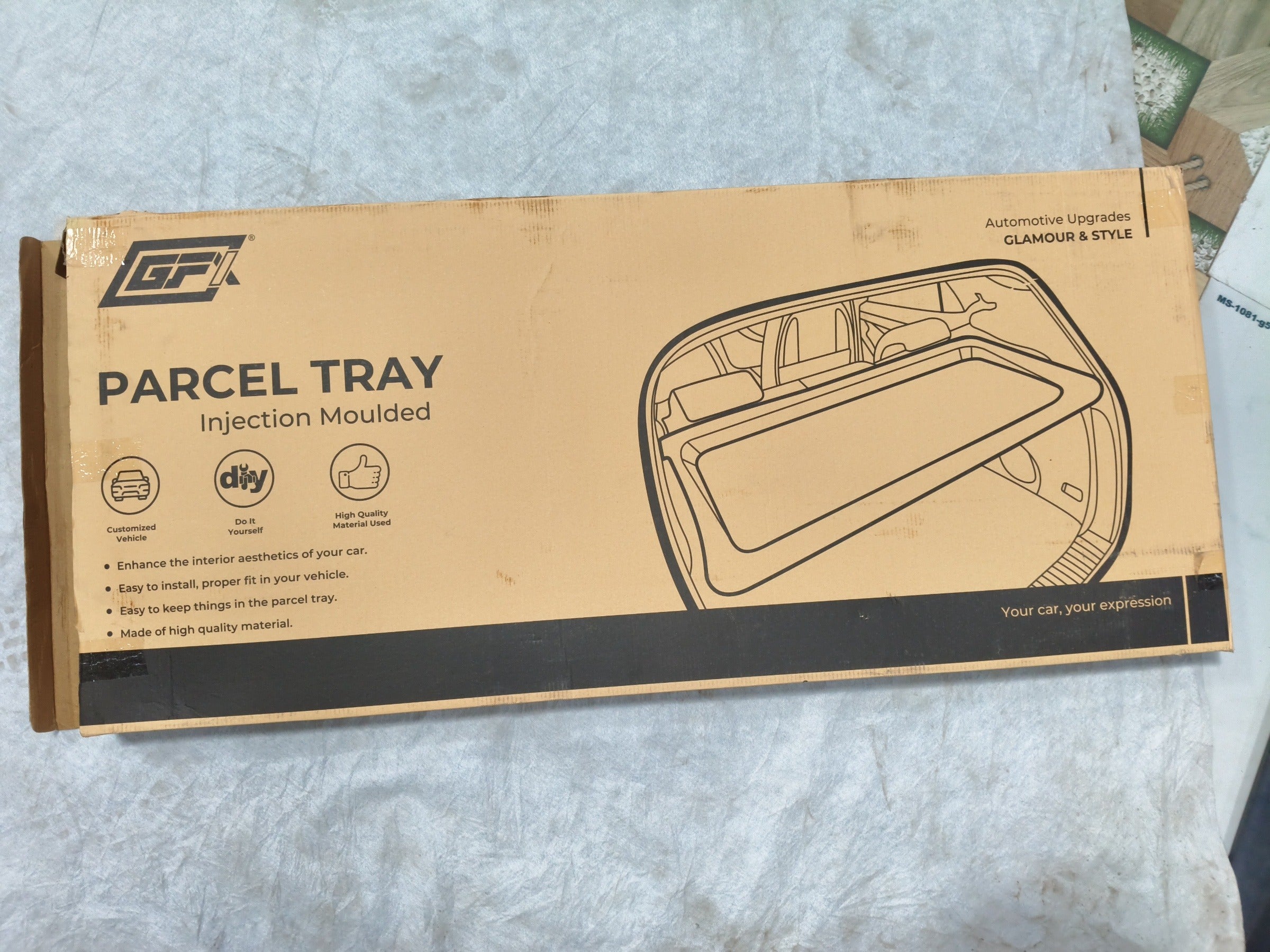 Black parcel tray for Hyundai i20 2020 model by Gfx, shown installed in the cargo area with a textured surface.