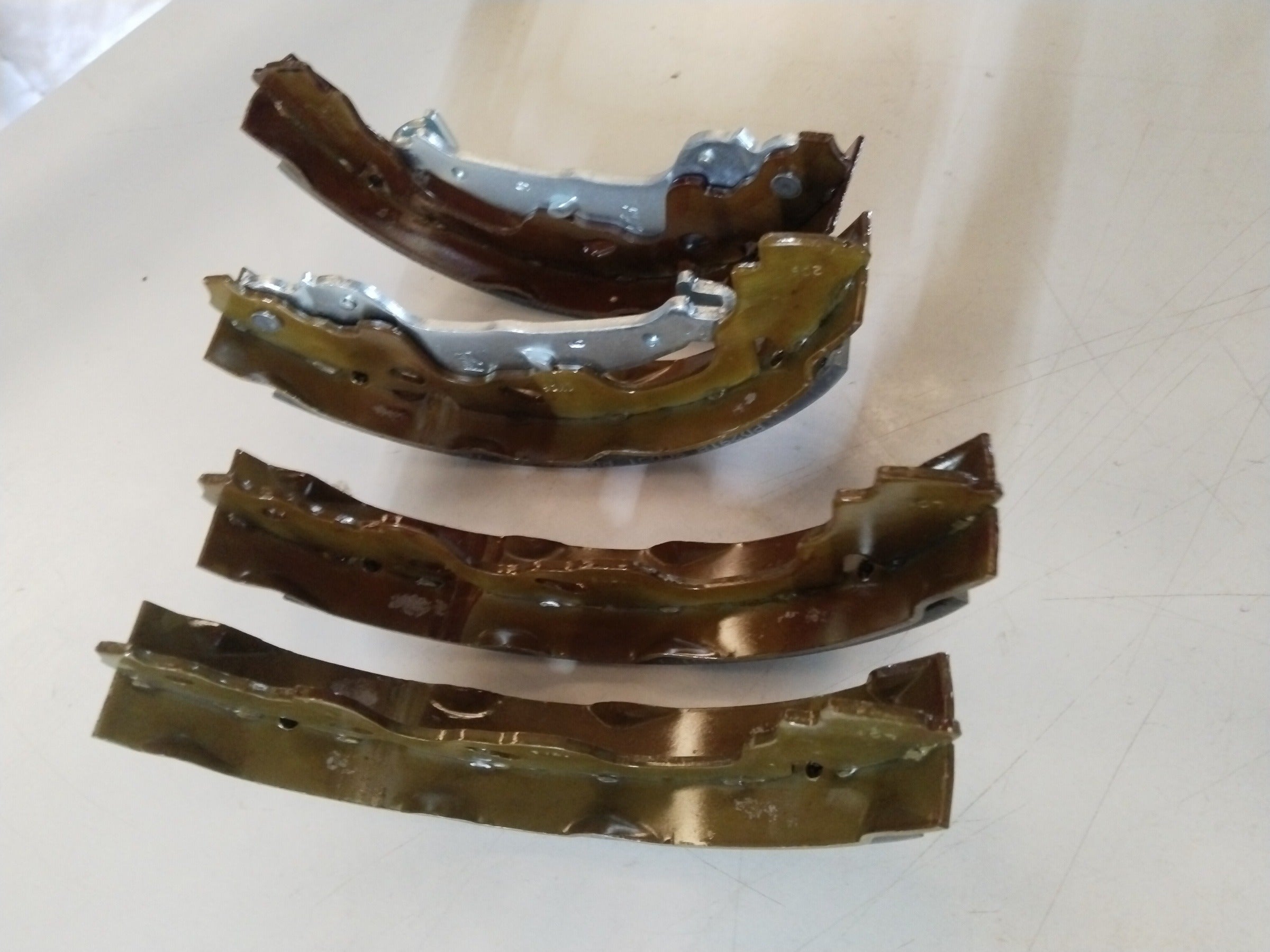 Rear brake shoe for Maruti Swift 1st Gen, Swift Dzire, and Esteem from CarTrends, showing the metal lining and shoe shape.