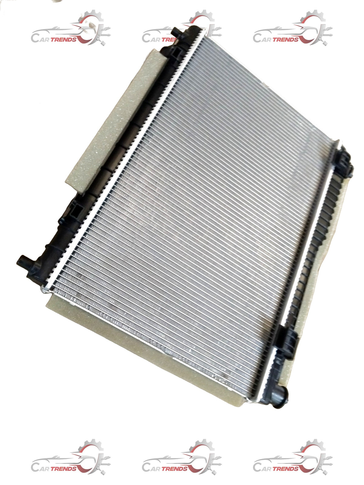 Ford radiator by CarTrends, showing a close-up of the aluminum core and side tanks for efficient engine cooling.