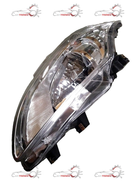 Maruti Ertiga headlight driver side with motor, CarTrends replacement part, clear lens showing reflector and mounting details.