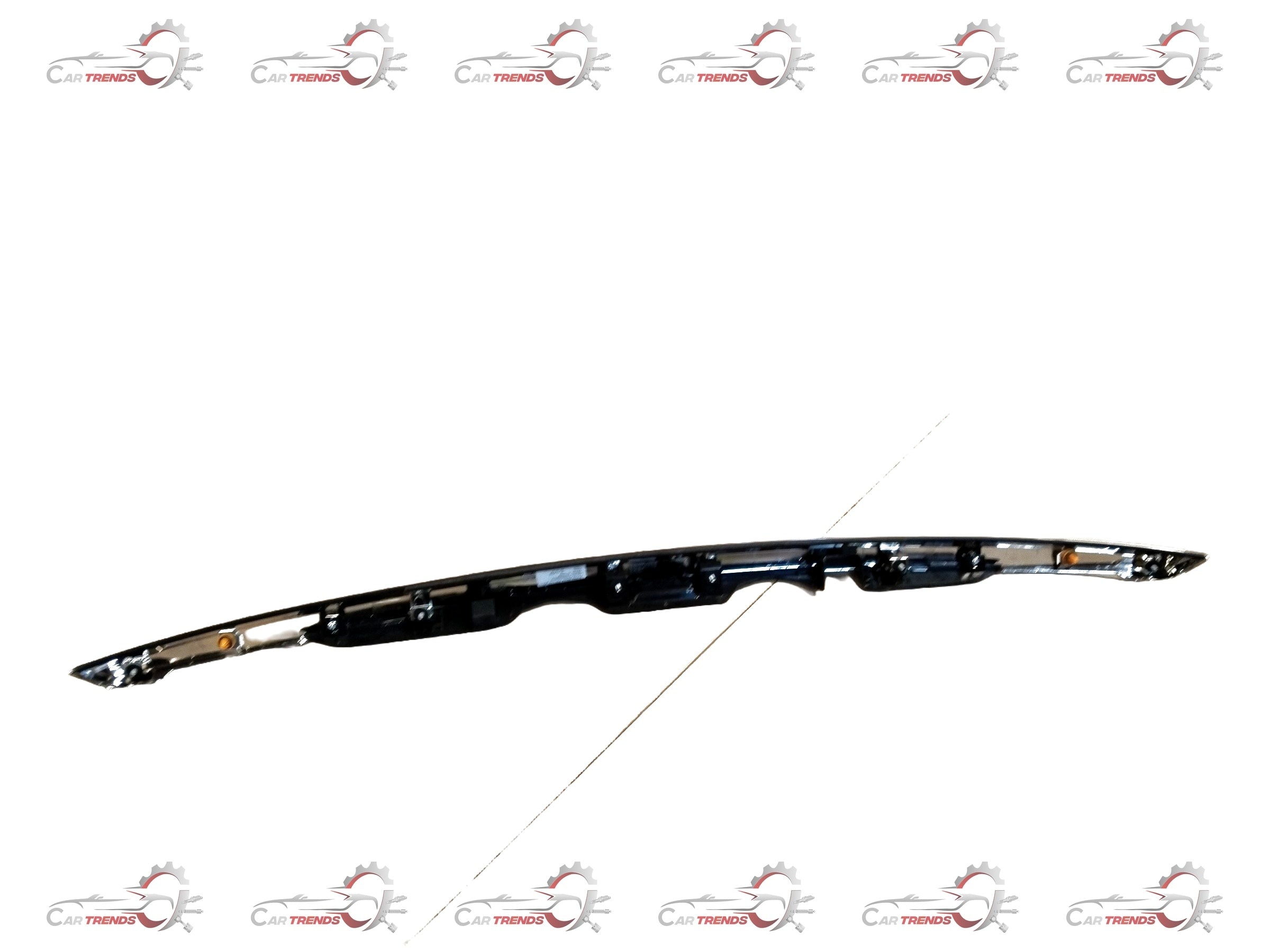 Maruti Suzuki garnish trunk lid for Dzire, showing close-up of the chrome trim and trunk surface with mounting details.