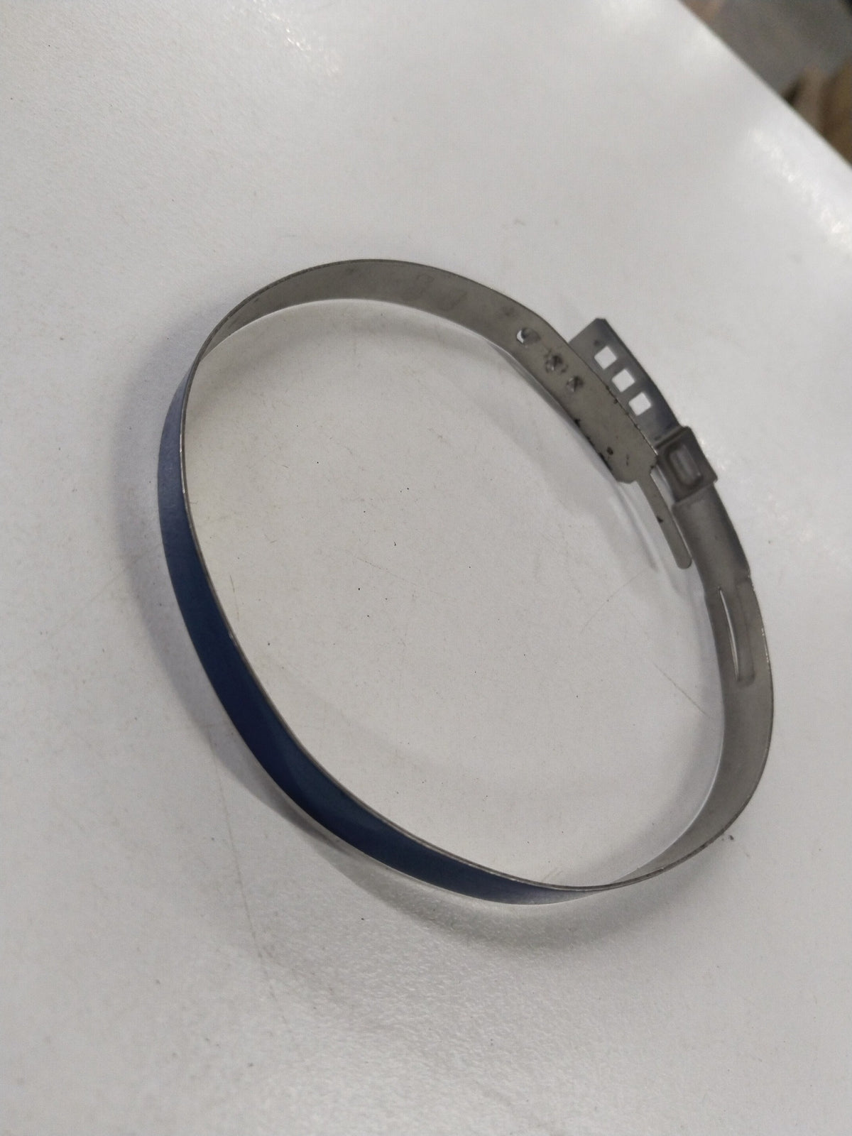General Motors Subaru Forester drive shaft band, automotive part, showing the metal band with bolt for securing the drive shaft.