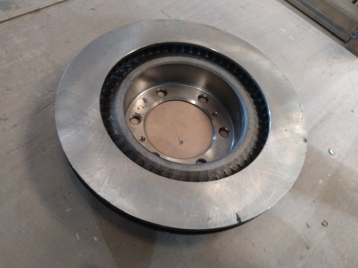 Toyota disc brake rotor, automotive part with vented design, shown in a close-up image, suitable for Toyota vehicles.