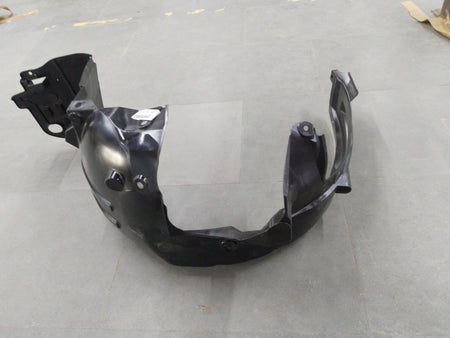 Honda Brio left front inner fender assembly, part #74150T08K00, showing the detailed inner structure and mounting points.