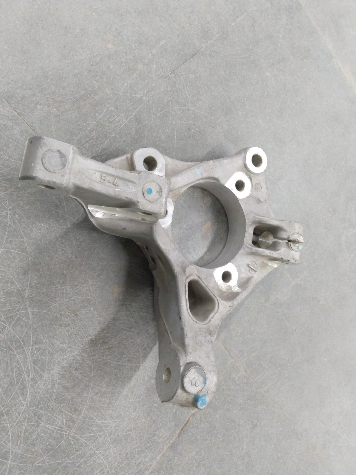 Image of a Chevrolet Cruze steering knuckle from General Motors, showing the metal component with mounting points and hardware.