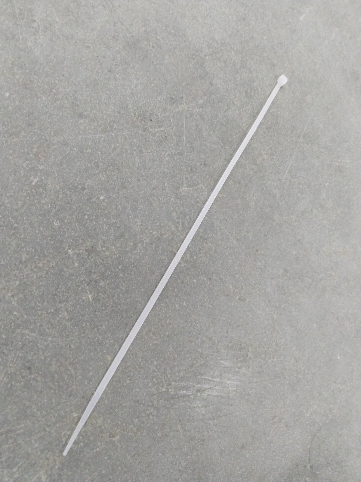 Close-up of an aftermarket tie clip featuring a sleek, polished design with the brand label visible in a two-photo image.