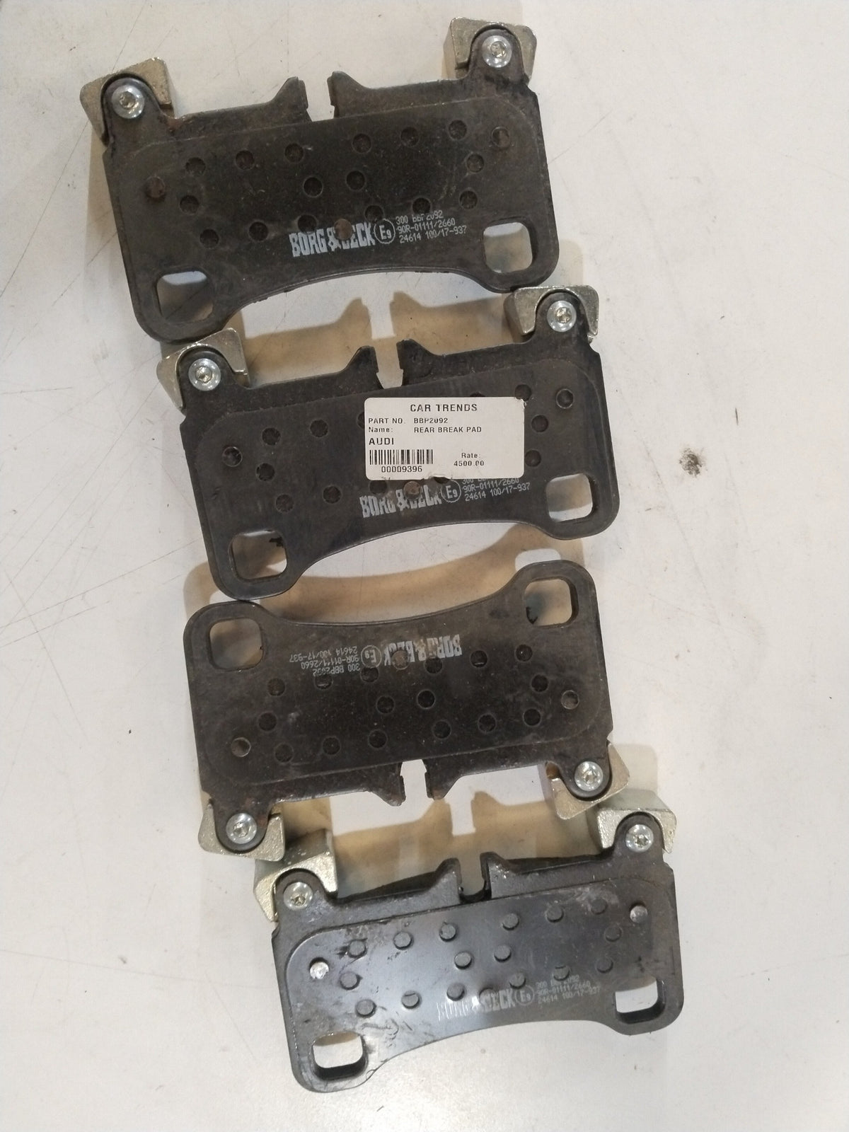 Pair of aftermarket front brake pads for Audi Q7, showing the metal backing and brake friction surface.