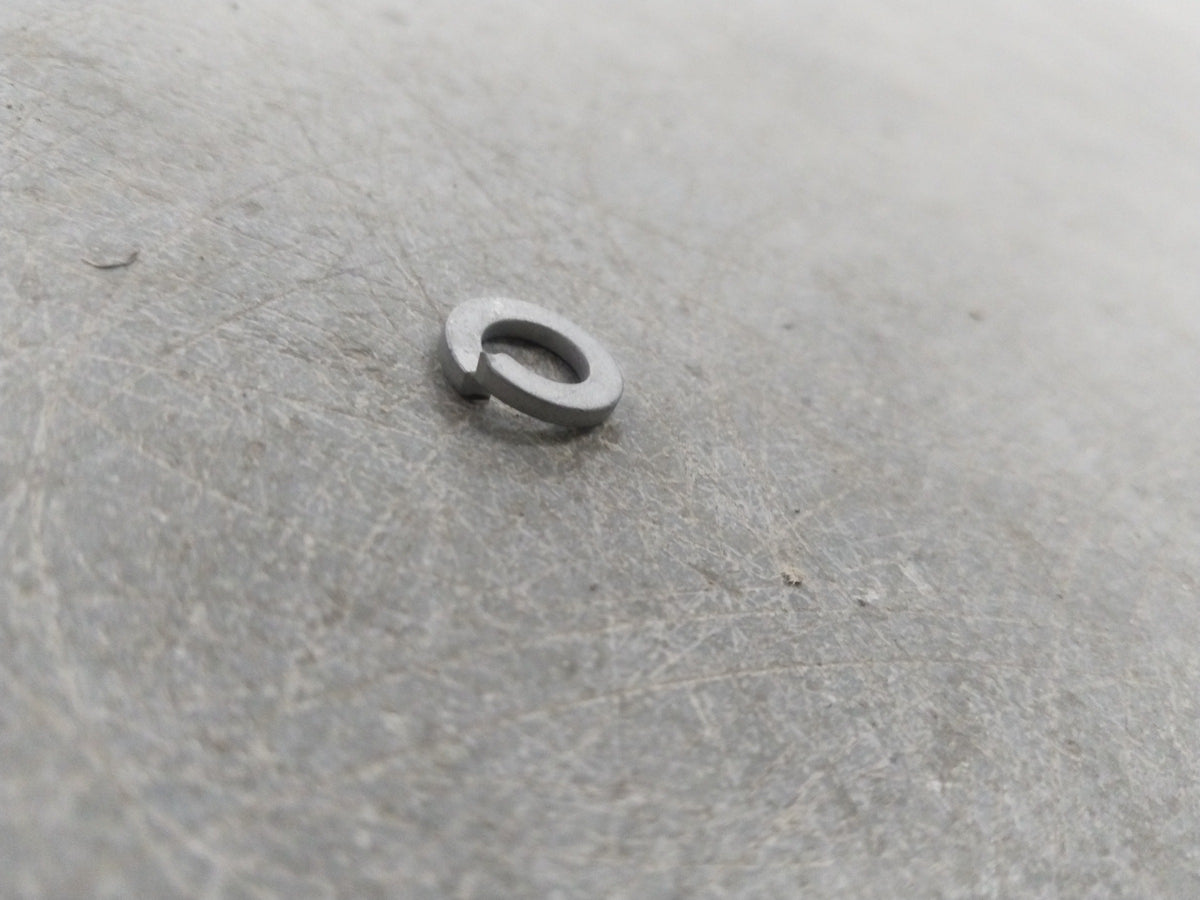 General Motors Chevrolet Corsa washer battery retainer shown in two images, securing the battery in place.