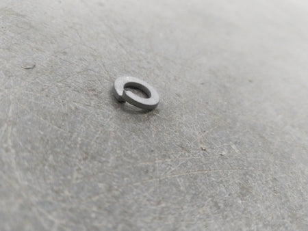 General Motors Chevrolet Corsa washer battery retainer shown in two images, securing the battery in place.