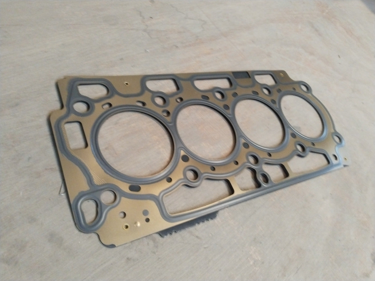 Ford cylinder head gasket with part number AV2Z6051D, showing a close-up of the gasket's surface and bolt holes.