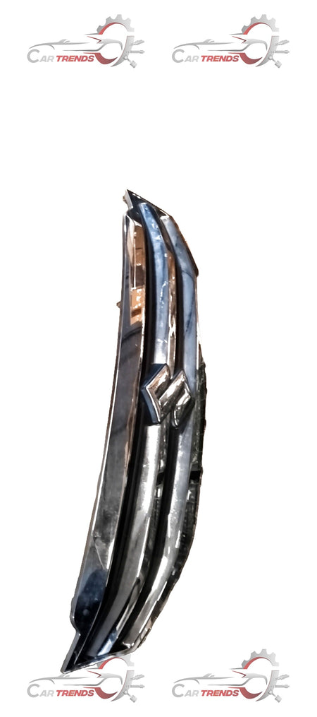 Maruti Suzuki grille compradator upper part for vehicle, showing the metal grille component with mounting details.