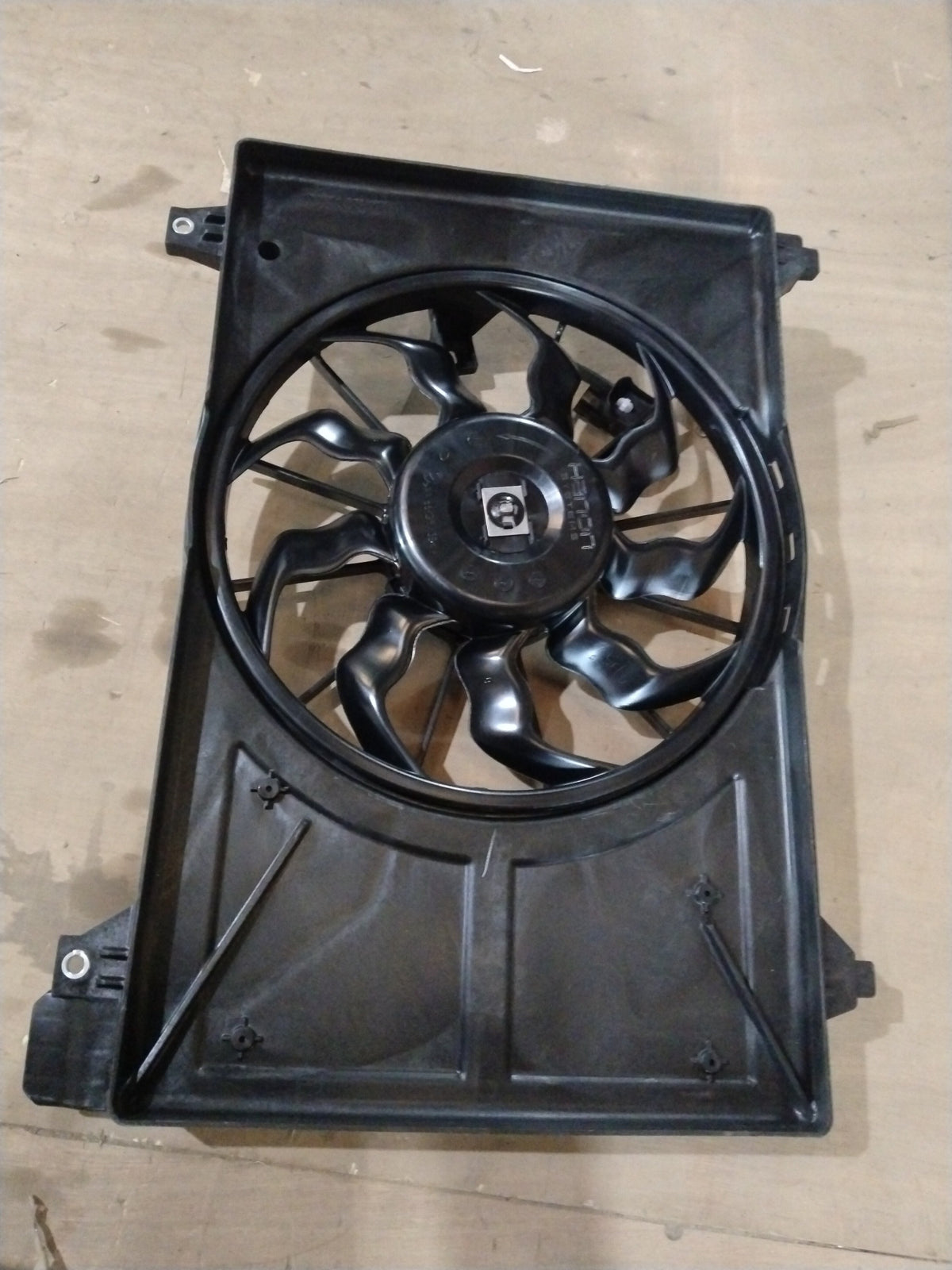 Maruti Suzuki cooling fan assembly for Suzuki Baleno, showing the fan motor and blades in a close-up image.