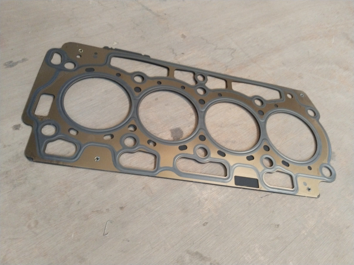Ford cylinder head gasket from CarTrends featuring a close-up view of the gasket’s detailed surface and sealing edges.