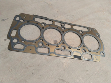 Ford cylinder head gasket from CarTrends featuring a close-up view of the gasket’s detailed surface and sealing edges.