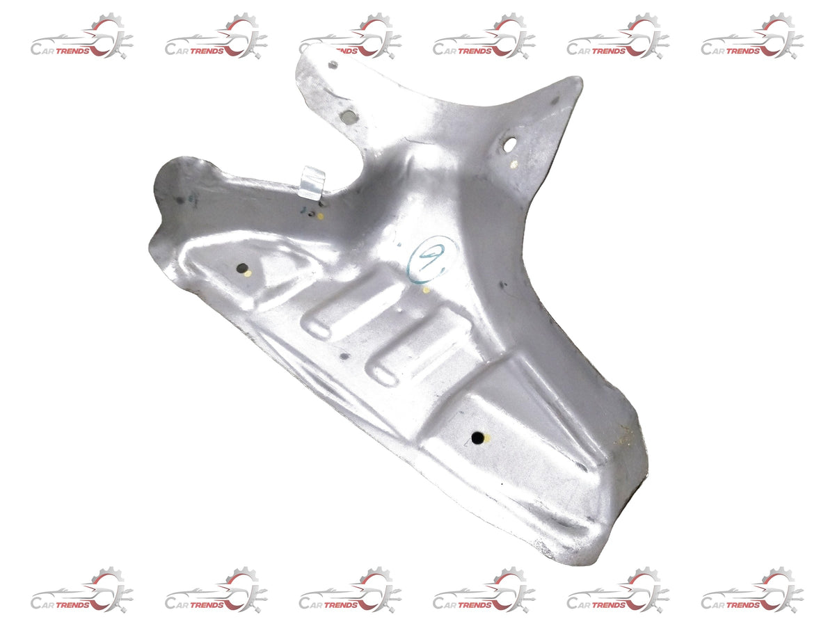 CarTrends Nissan Micra exhaust manifold cover, showing a black metal part with mounting holes and textured surface close-up.