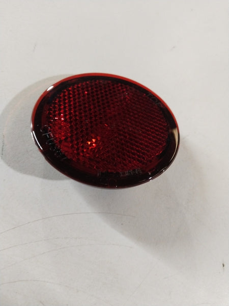 Nissan Kicks rear reflector with reflective surface, mounted on the vehicle's rear, designed for enhanced visibility and safety.