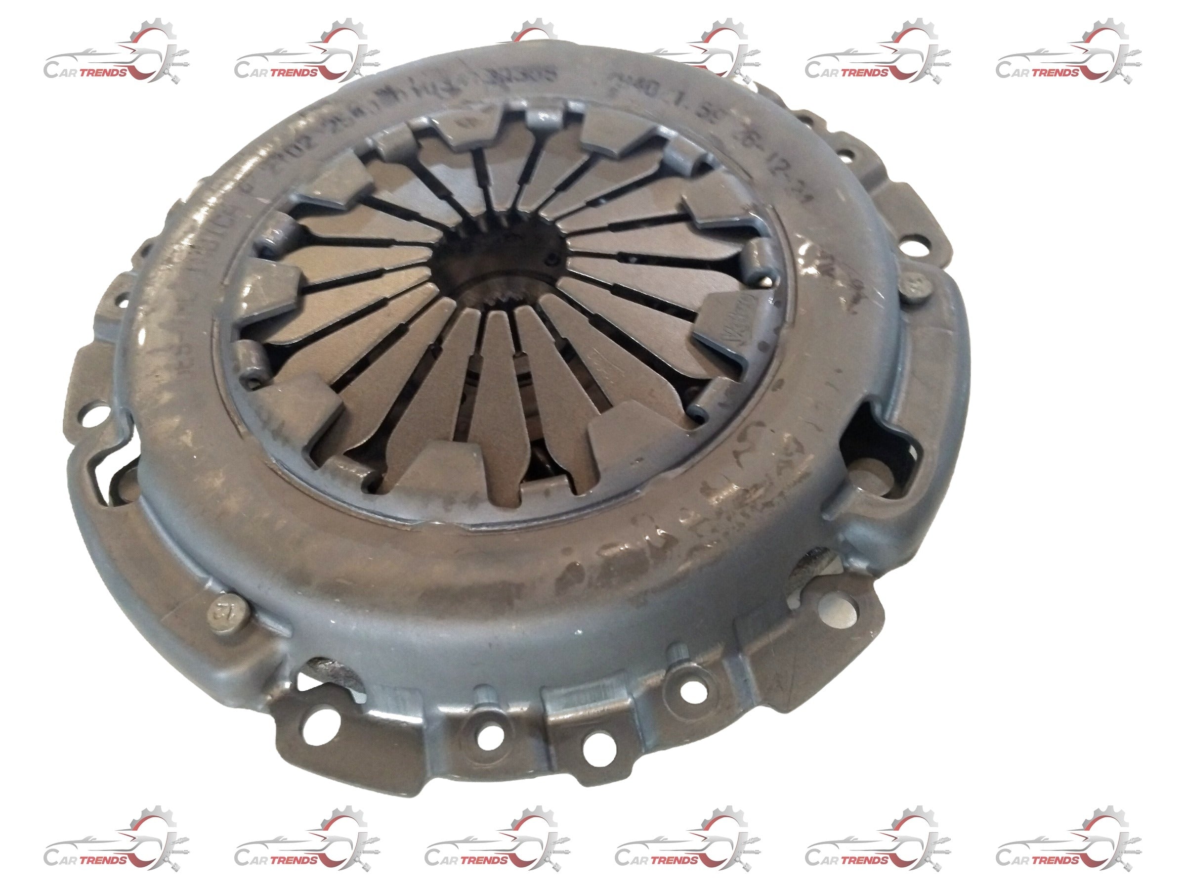 Tata Indica Xeta clutch and pressure plate kit showing metal clutch components and pressure plate assembly in a natural setting.