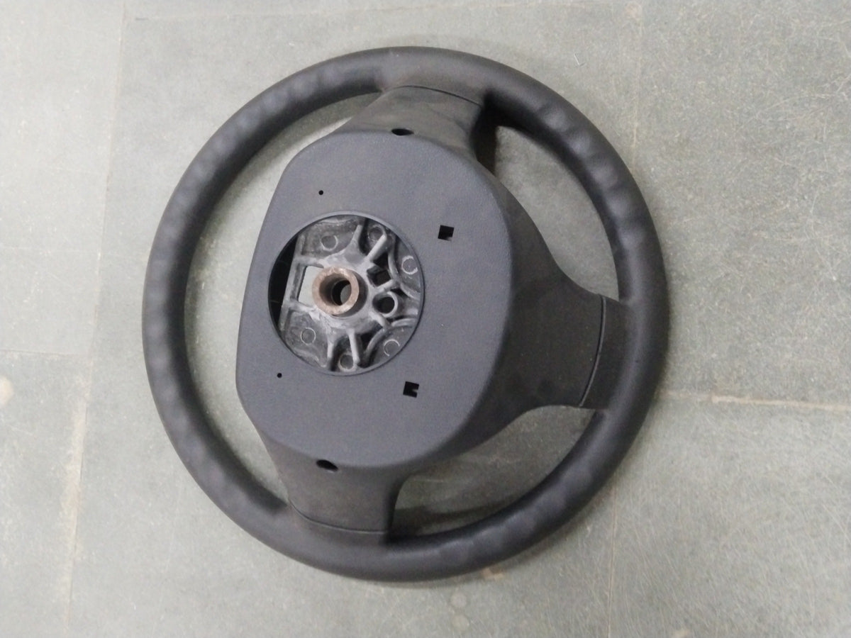General Motors Chevrolet Enjoy steering wheel assembly with visible spokes and central hub for vehicle control.