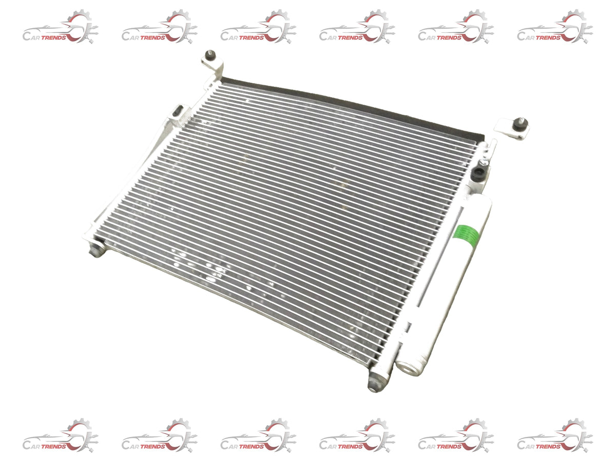 General Motors Chevrolet Enjoy condenser assembly for AC system, showing the metal components and fittings on a white background.