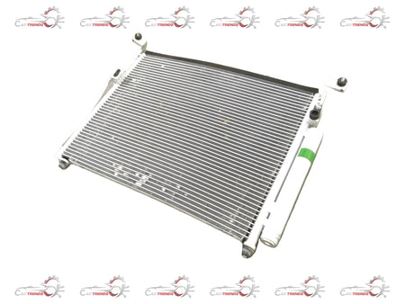 General Motors Chevrolet Enjoy condenser assembly for AC system, showing the metal components and fittings on a white background.