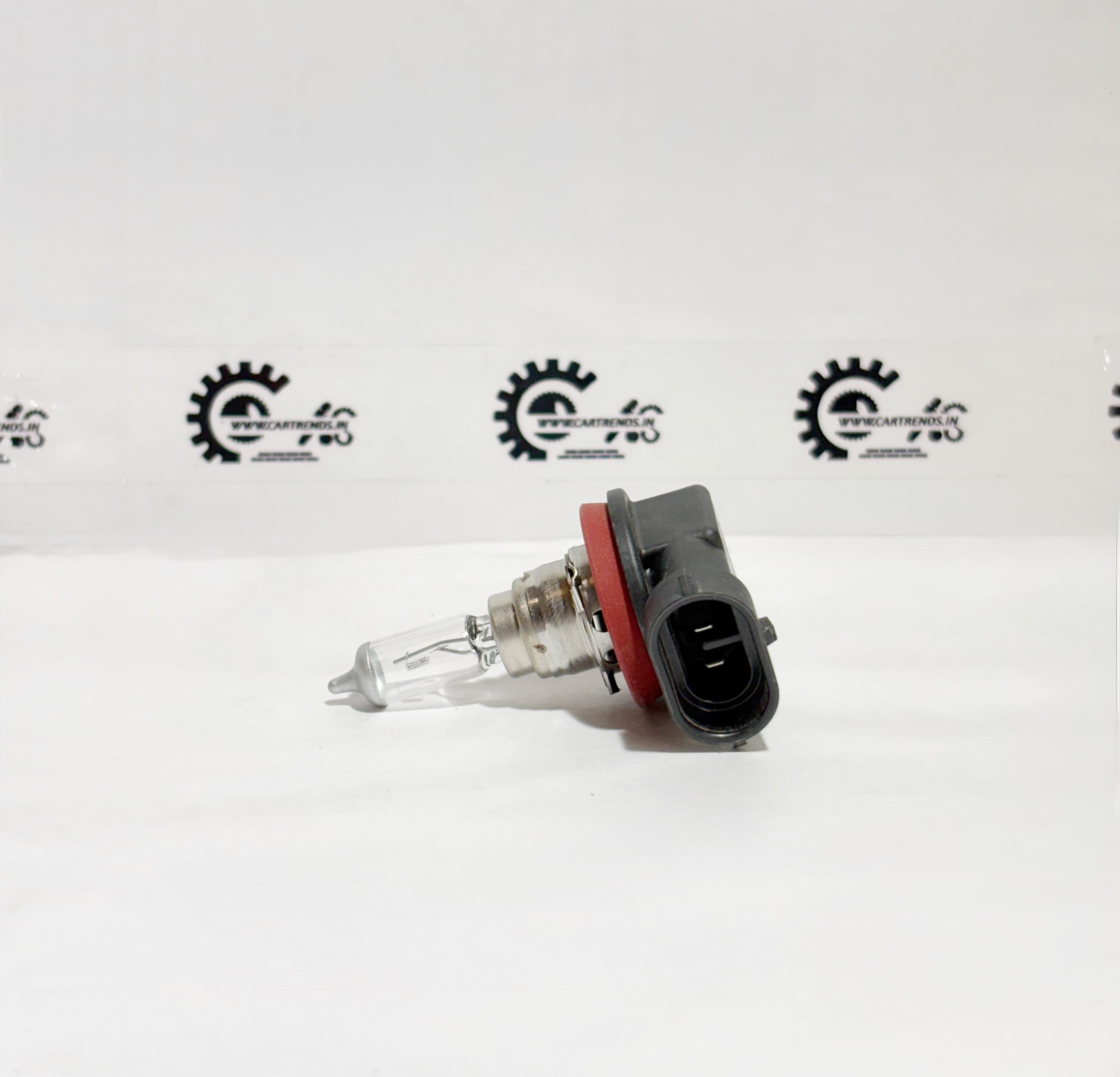 Honda H16 33165TXKK01 bulb installed in a vehicle headlight, showing the left side with a clear view of the bulb and socket.