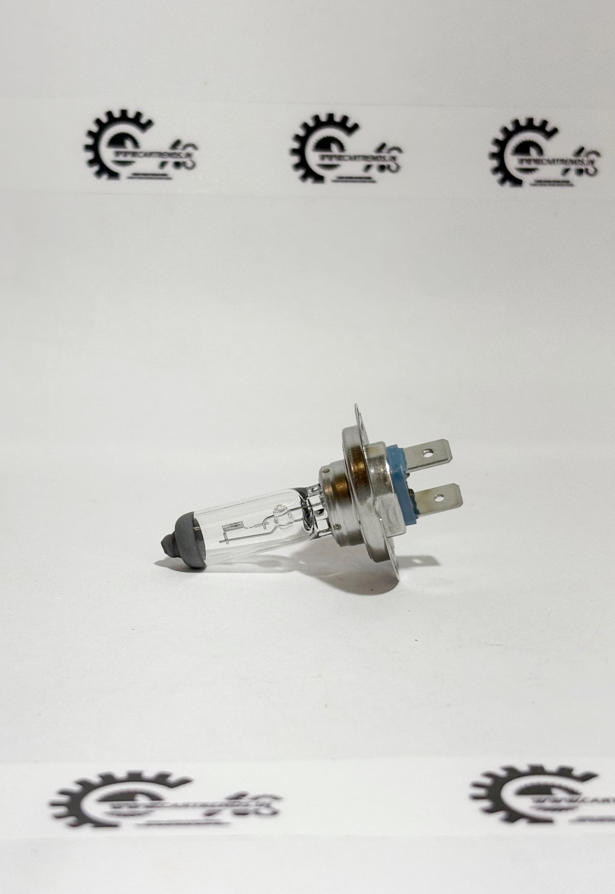 Honda BULB.H7 LL 33110SMGE01 headlight bulb installed in a vehicle's left side headlamp assembly.
