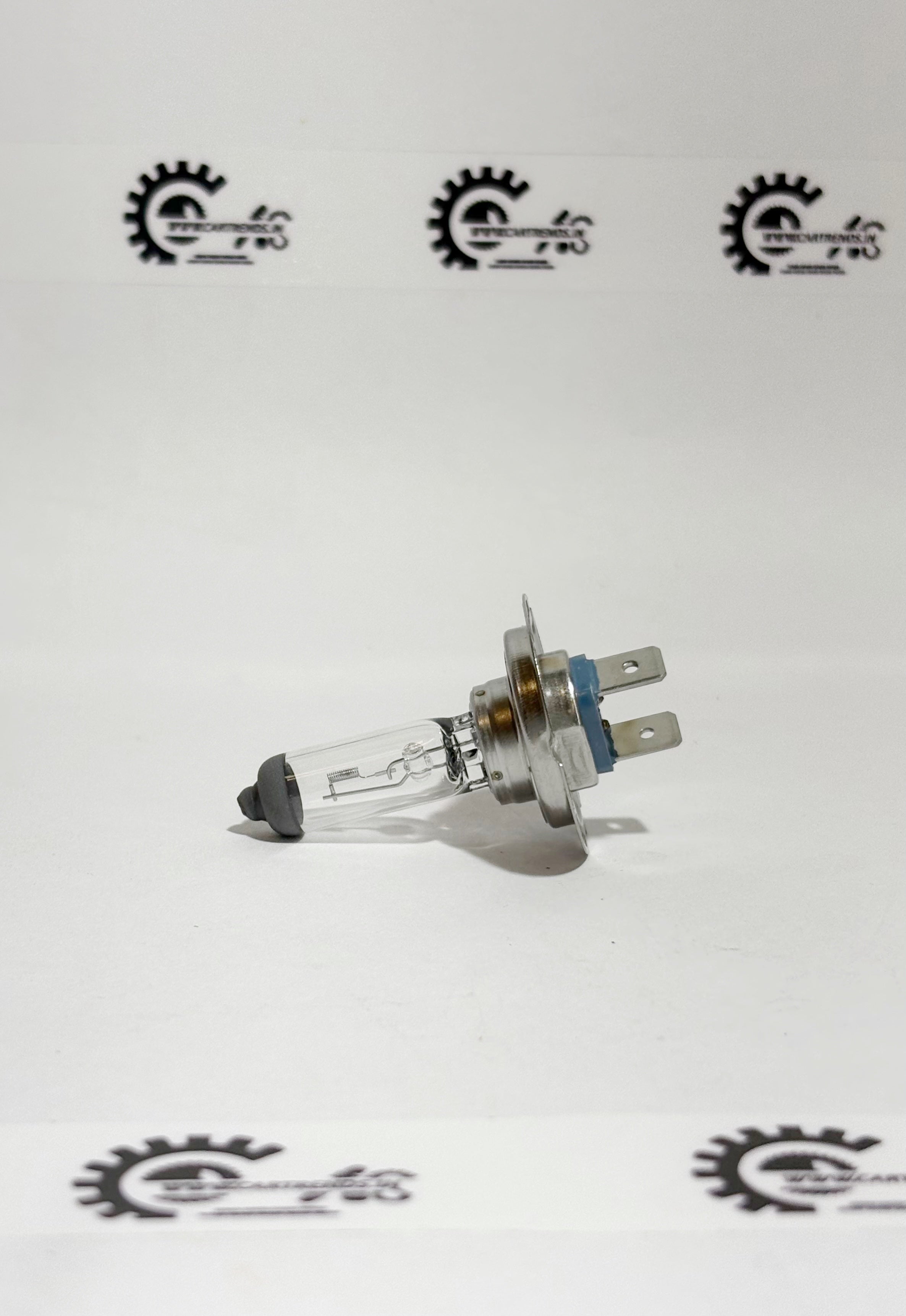 Honda BULB.H7 LL 33110SMGE01 headlight bulb installed in a vehicle's left side headlamp assembly.