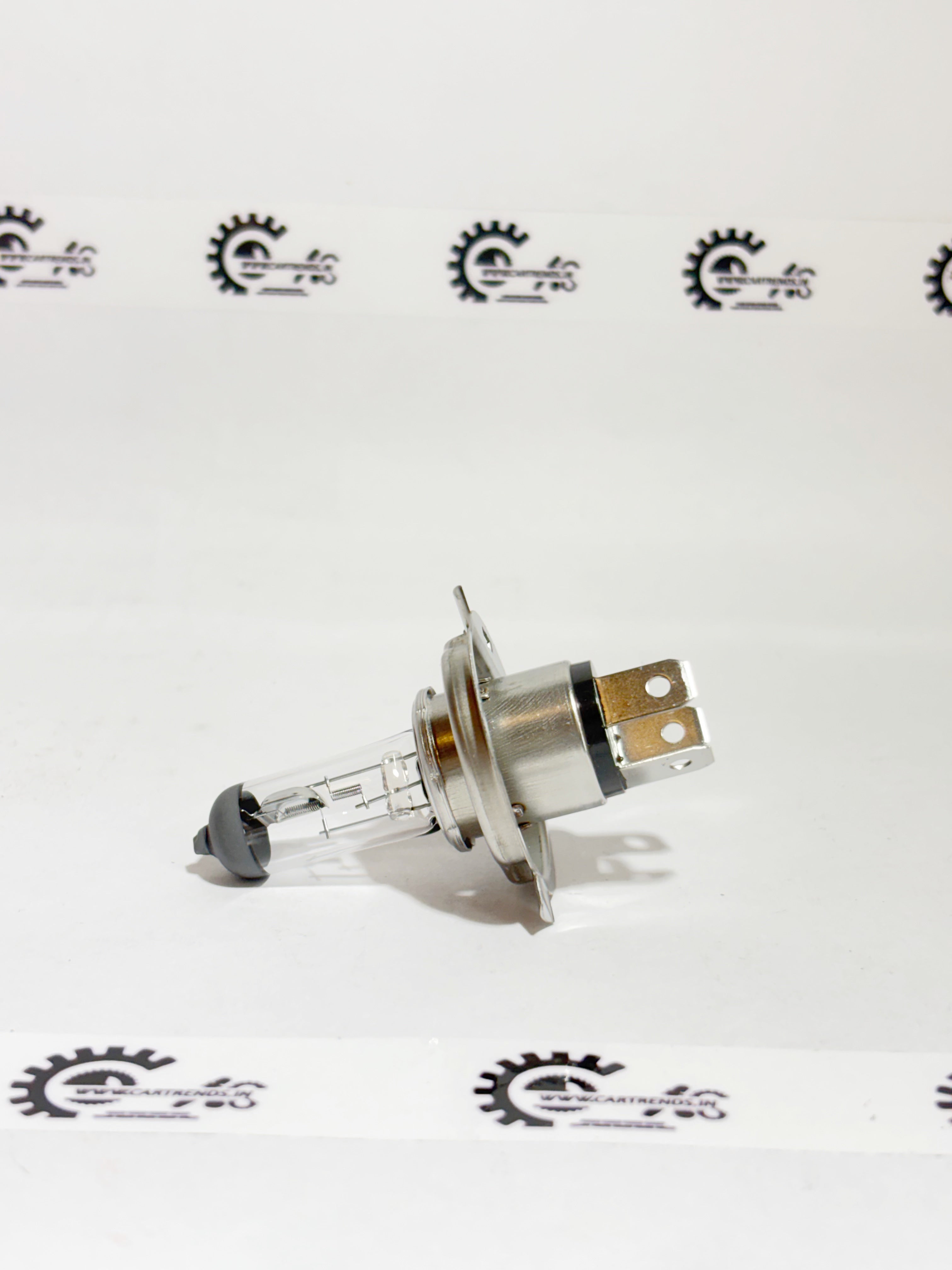 Honda H4 headlight bulb, model 33115SV4003, installed in the left headlight of a Honda vehicle.