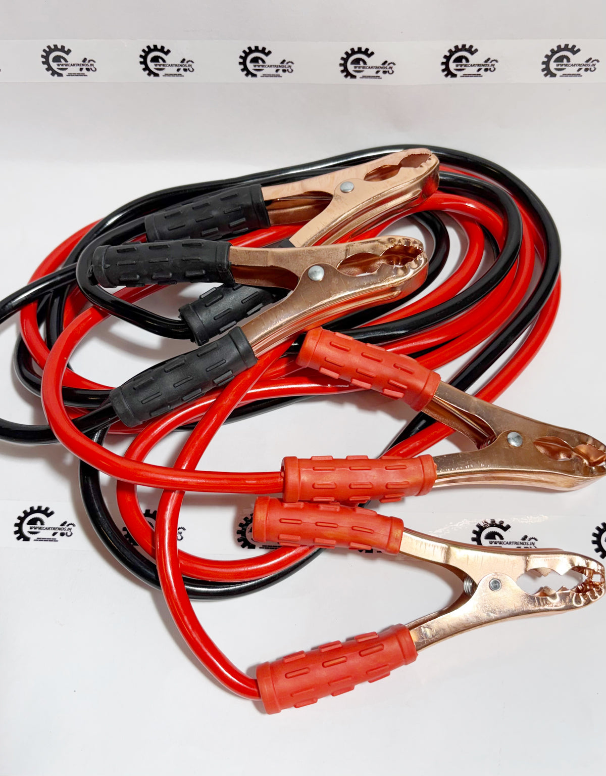 Honda jumper cable kit with black and red cables, designed for vehicle jump-starting, shown from the left side.