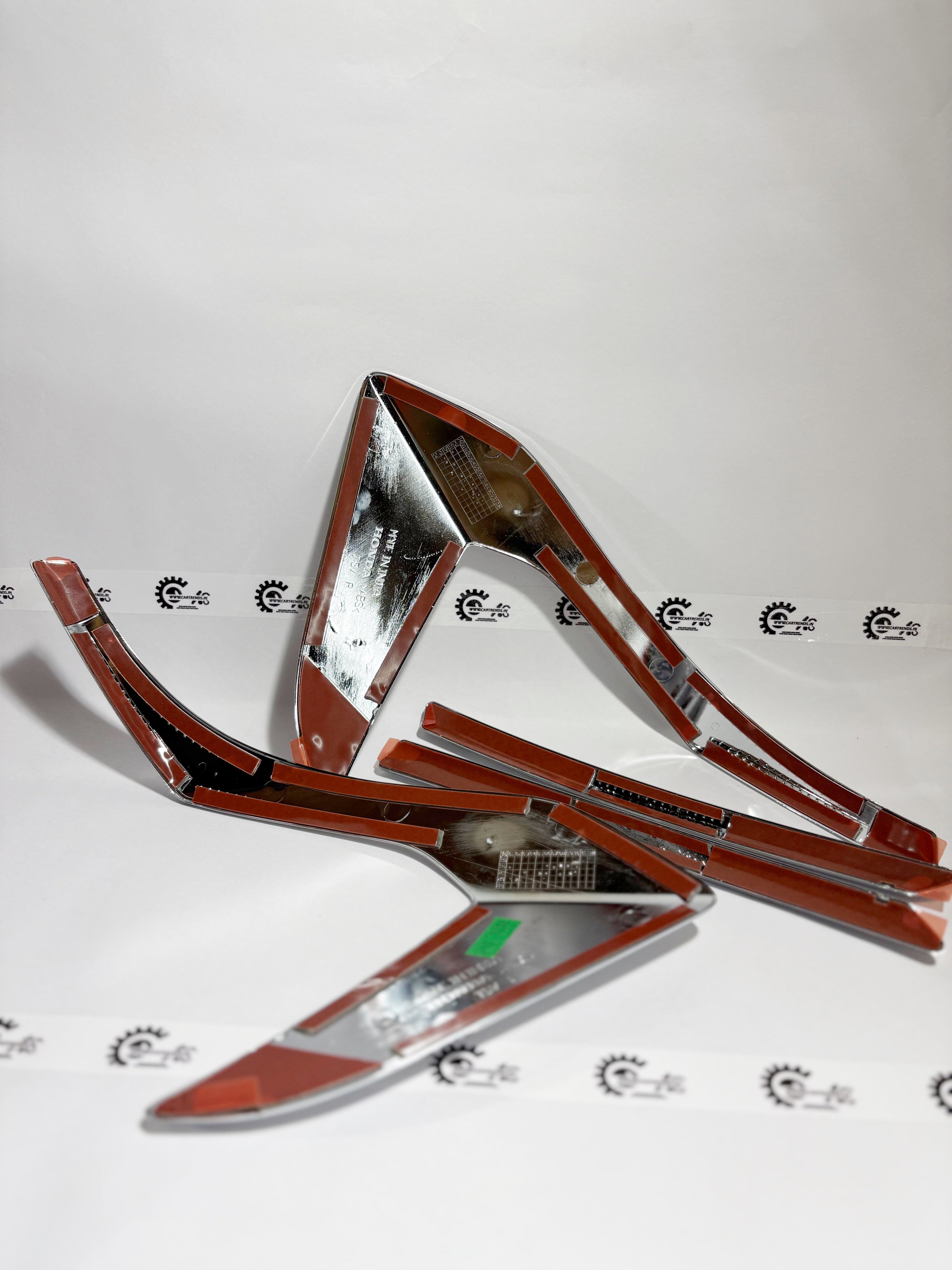 Honda tail lamp garnish kit, left side, for Honda vehicle, featuring sleek design and fitment details.