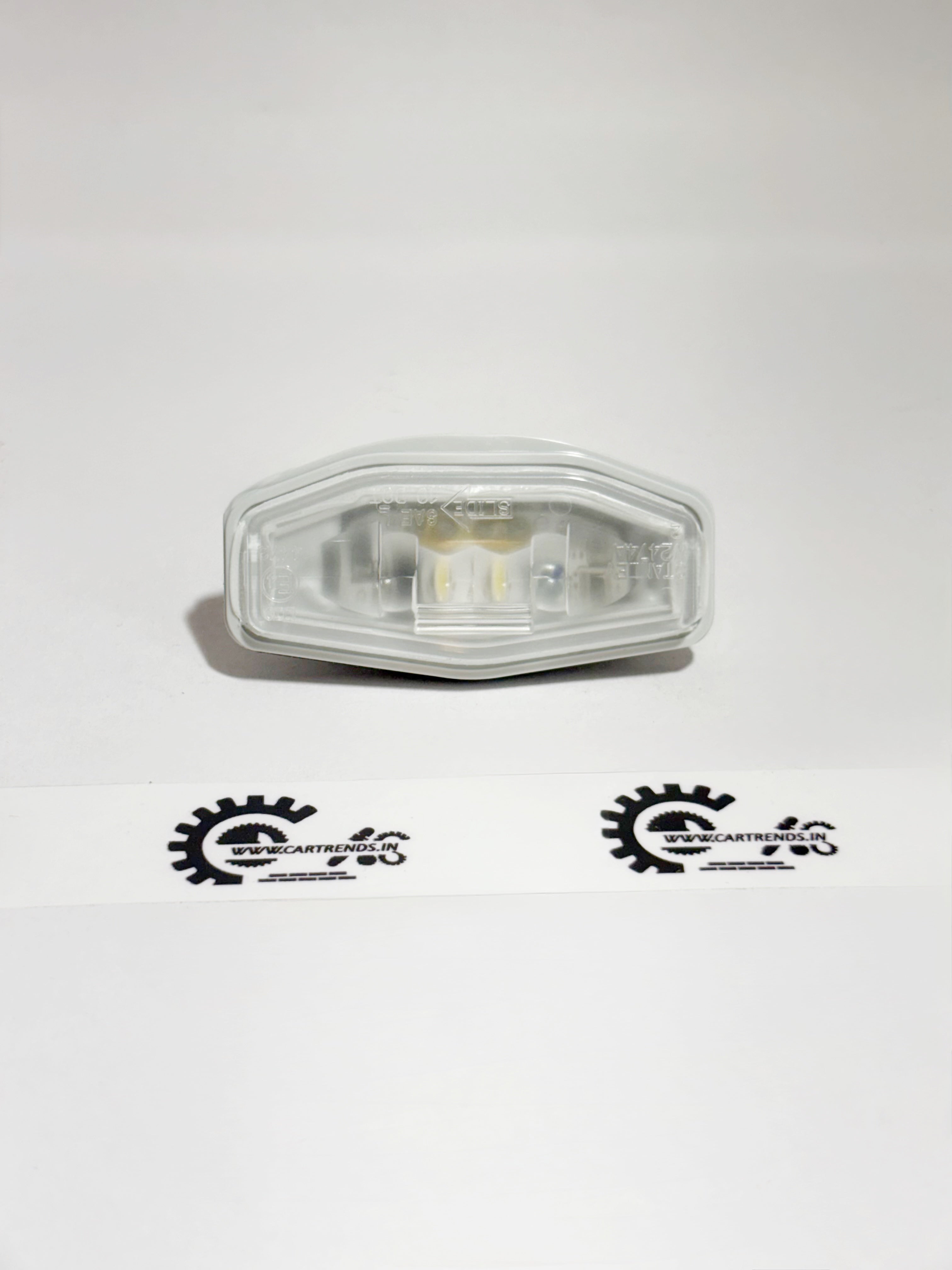 Honda license light assembly, part 34100T9A003, showing the front view of the vehicle's license plate illumination light.
