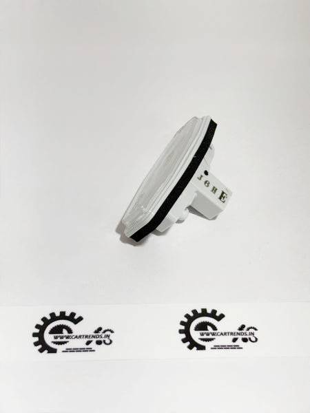 Honda license light assembly part 34100T9A003, left side view showing lens and mounting details