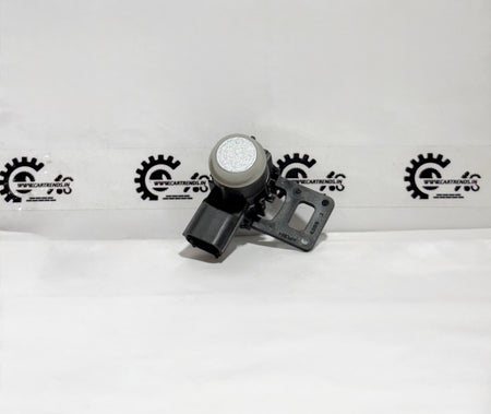 Honda parking sensor assembly with clip, shown on the front of the vehicle in a close-up view.