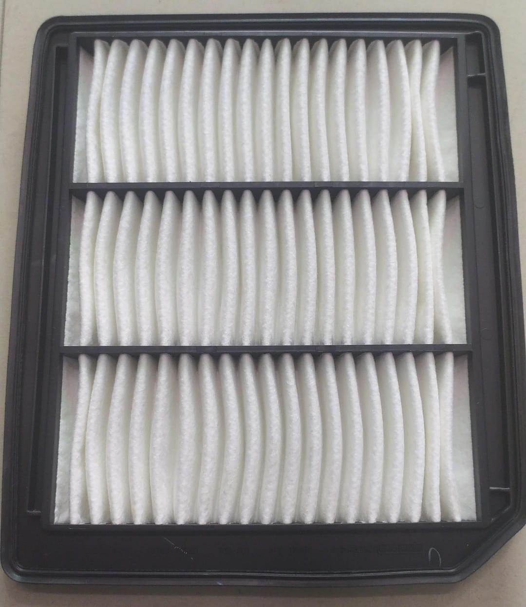 Maruti Suzuki Baleno new model air filter 13780M76SA0, showing the rectangular filter with pleated filter material.