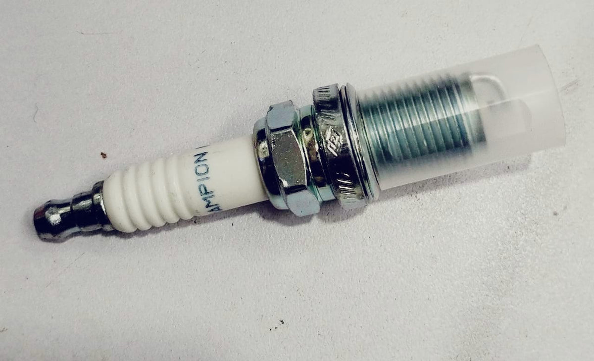 Aftermarket RC10YC spark plug with metal shell and ceramic insulator, designed for automotive engines.